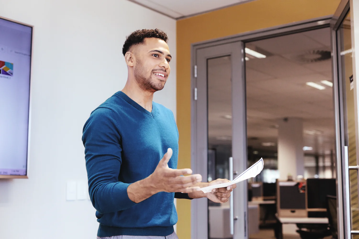 Confident mail professional holding documents.